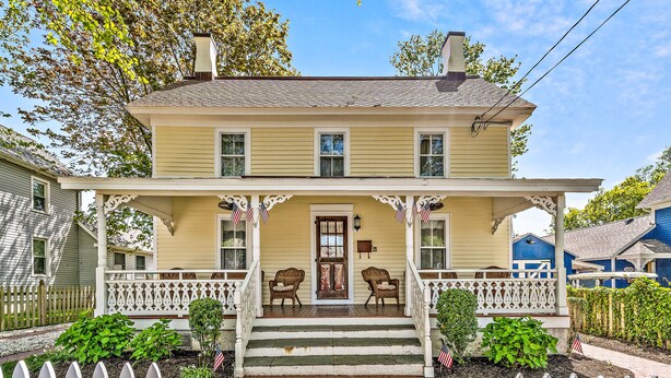 A two-story house with a porch, steps, and a picket fence. - Sea Horse Cottage-5 Bedrooms, 3 Full Baths, 2 Half Baths, Sleeps 14 (West Cape May)