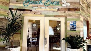 A beach-themed cafe with a rustic wooden facade, a glass door entrance, and potted plants. - Lovely Sapphire Beachfront Condo - Snorkel Crystal Cove - Paradise ! (St Thomas)