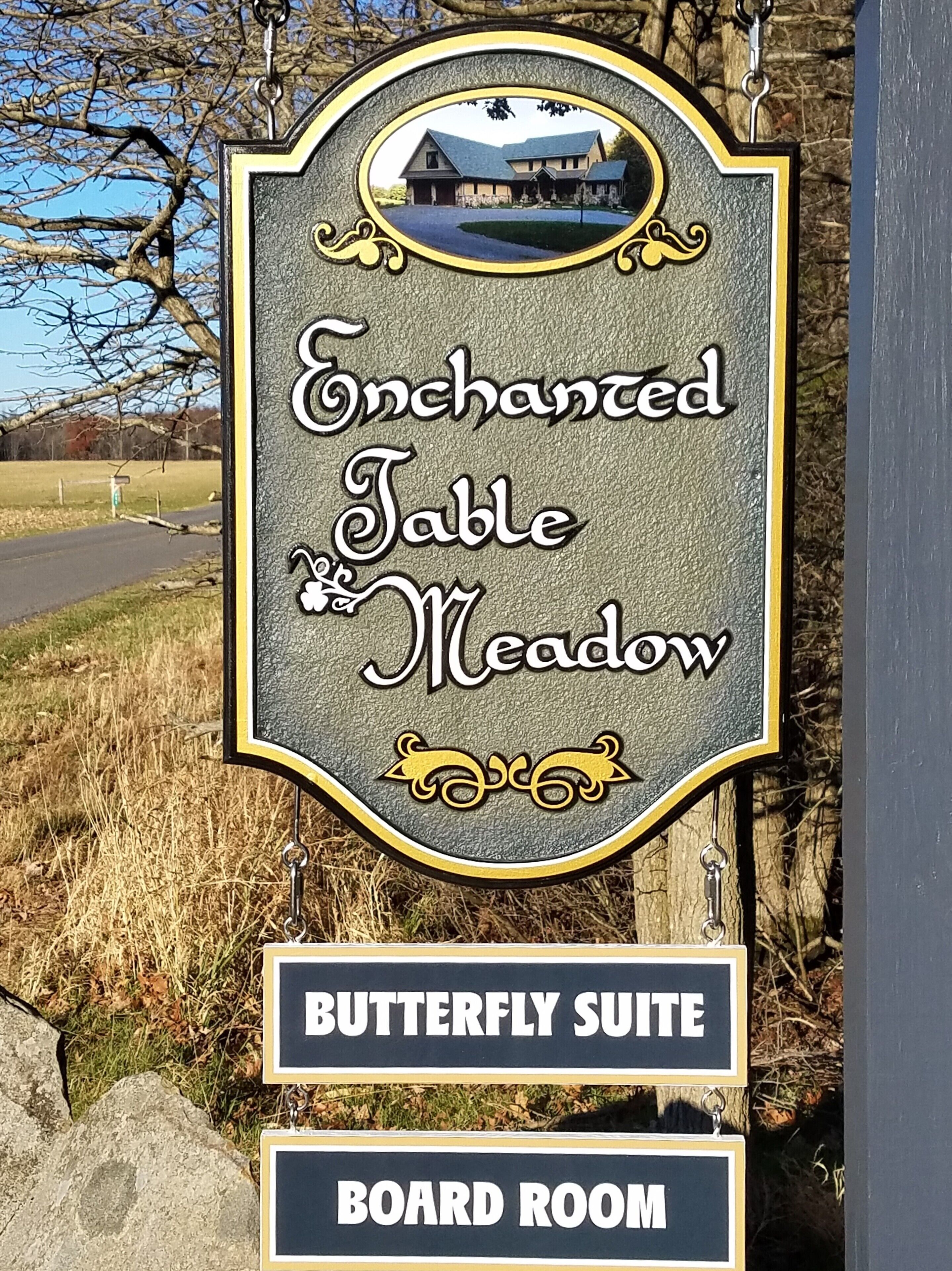 A sign for 'Enchanted Table Meadow' featuring a 'Butterfly Suite' and 'Board Room'.