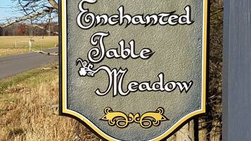 A sign for 'Enchanted Table Meadow' featuring a 'Butterfly Suite' and 'Board Room'.