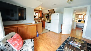A compact living space with a kitchen, a dining area, and a living room.
