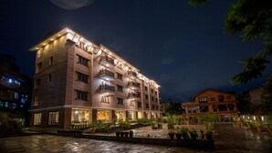 A multi-story hotel with a courtyard, balconies, and potted plants. - Hotel Bhadgaon (Bhaktapur)