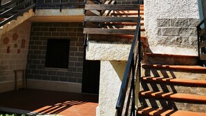A building with a brick exterior, a wooden staircase, and a balcony. - Chalet "Mon Amour" - Relax & Sky (Campo di Giove)