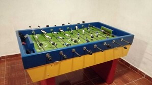 A colorful foosball table with a green playing surface and red legs. - El Teotihuacano is 1.5 km away. From the archaeological zone (San Juan Teotihuacan)