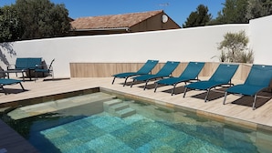 A swimming pool with clear water, surrounded by wooden deck and blue lounge chairs. - 5 minutes from the beaches , Villa with  Pool, Boulodrome, Pinball and Babyfoot (Vendres)