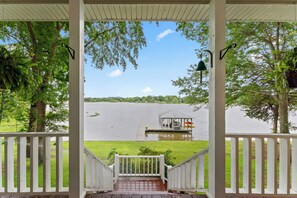 A covered deck with a view of a lake, a gazebo, and a grassy area. - Lay Lake - On main Channel in private area. With Hot Tub and Kayaks (Wilsonville)