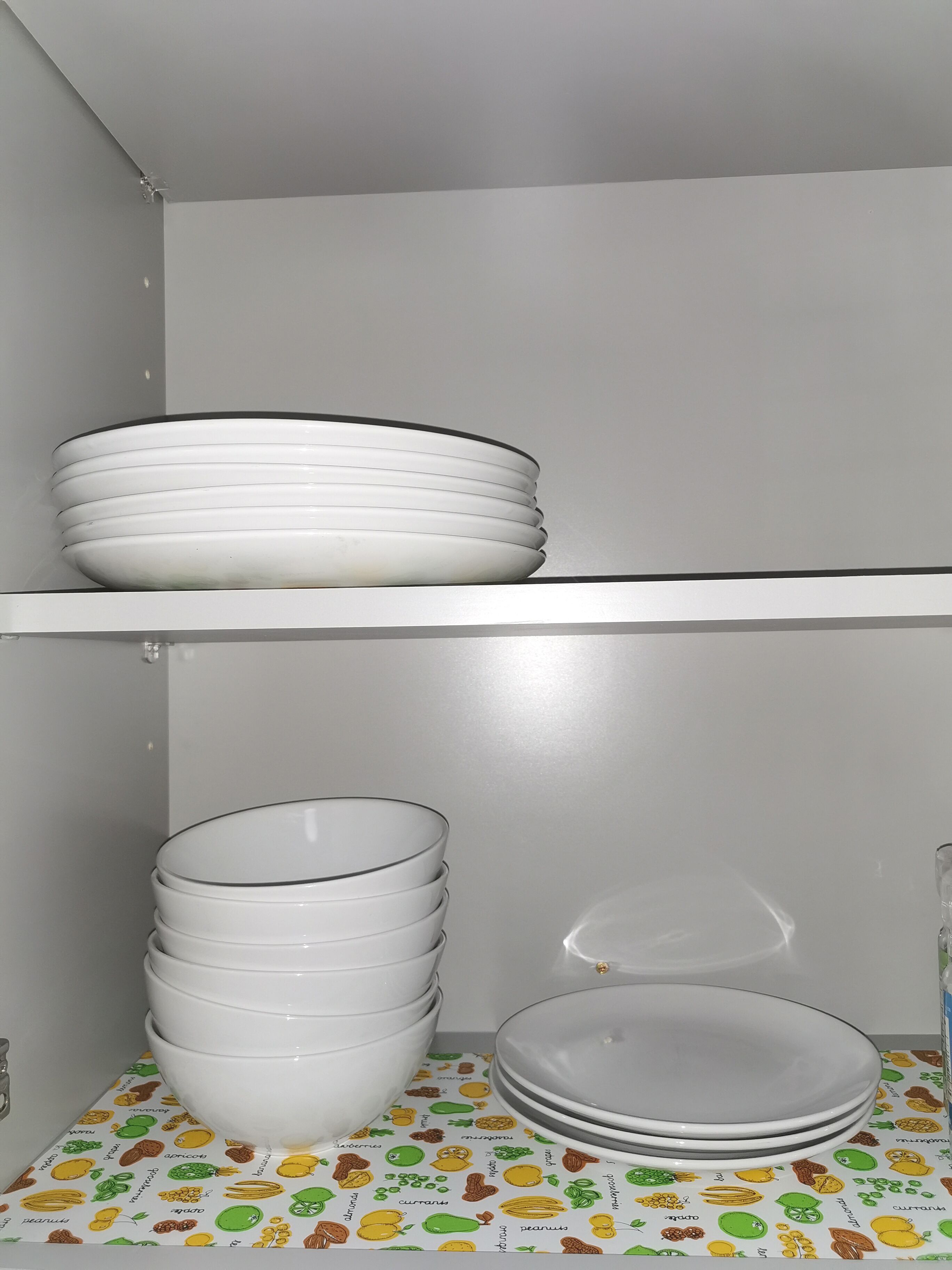 A kitchen with white cabinets and a countertop.