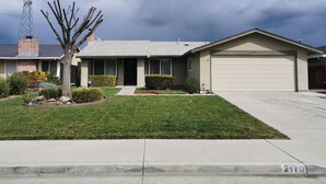A single-story house with a garage, a well-maintained lawn, and a utility pole in the background. - Beautiful, Safe, Clean, Spacious 2 bd/1ba in N San Jose 951311 (San Jose)