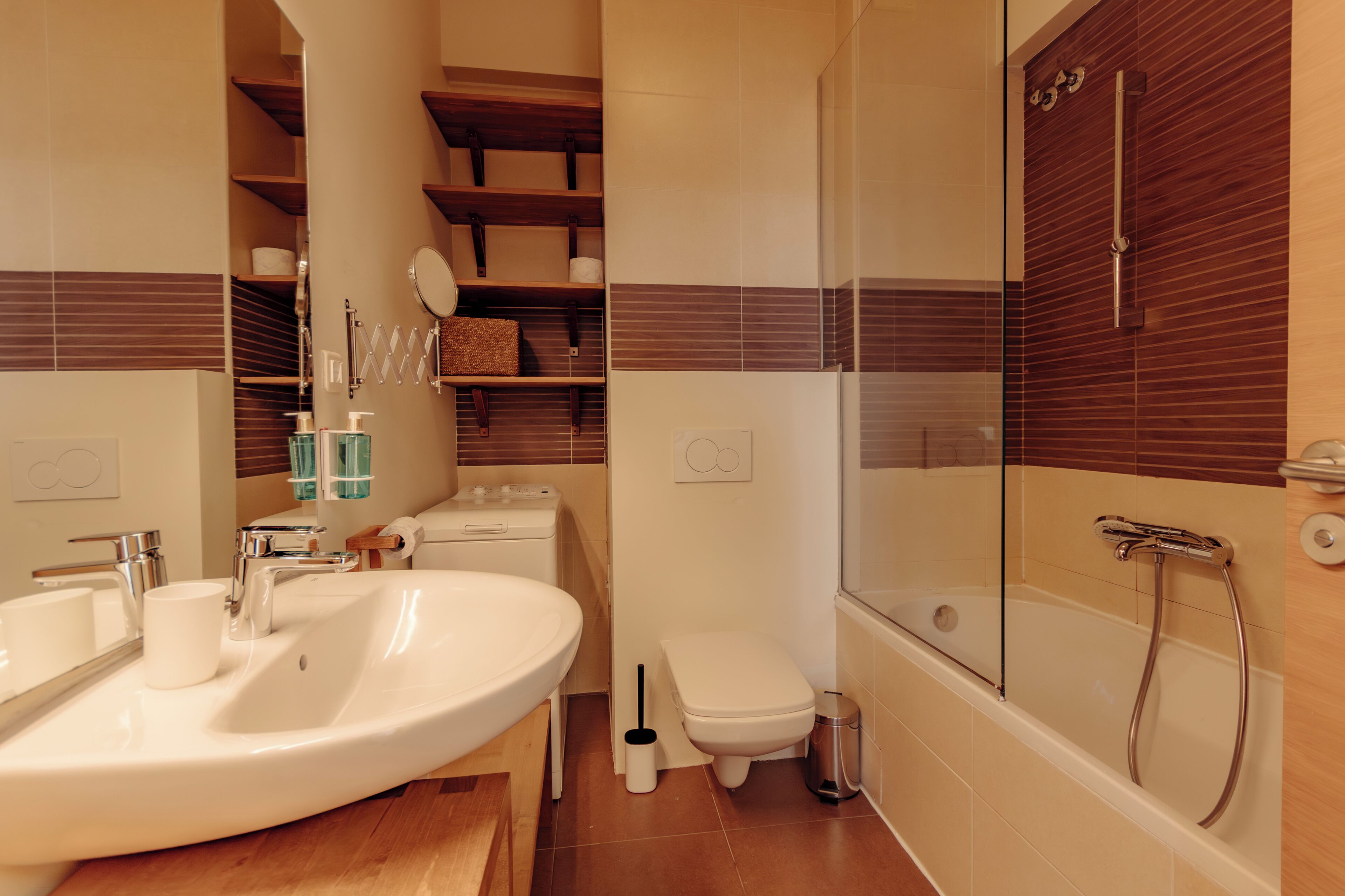A modern bathroom with a large sink, toilet, and shower.