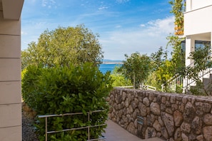 Enjoy breathtaking views of the sea and distant hills from this property's lush surroundings.