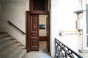 A staircase leading to a room with a view of a building. - Monteoliveto Modern Flat by Wonderful Italy (Napoli)