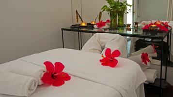 Restful retreat with a neatly made bed, featuring white linens and a touch of tropical charm.