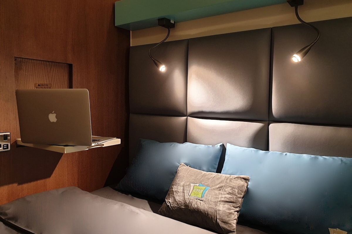 laptop workspace, bed sheets