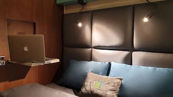 Laptop workspace, bed sheets