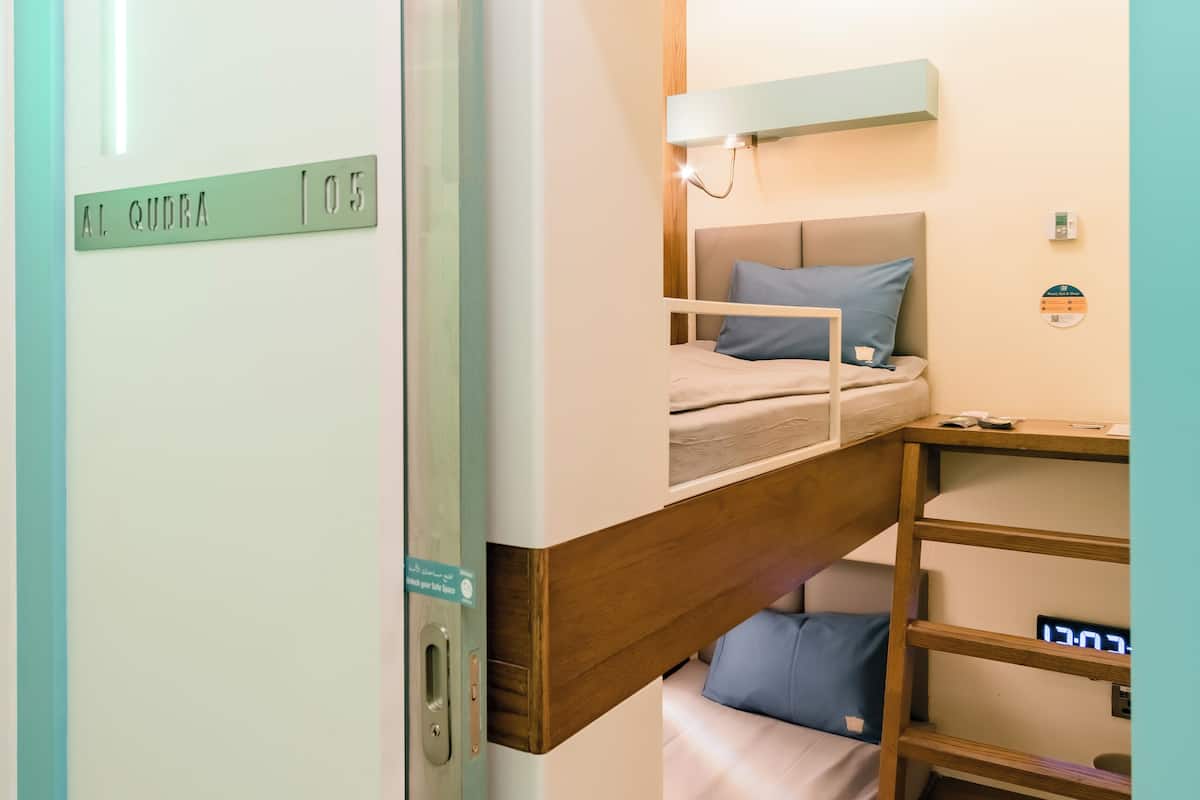 Laptop workspace, bed sheets