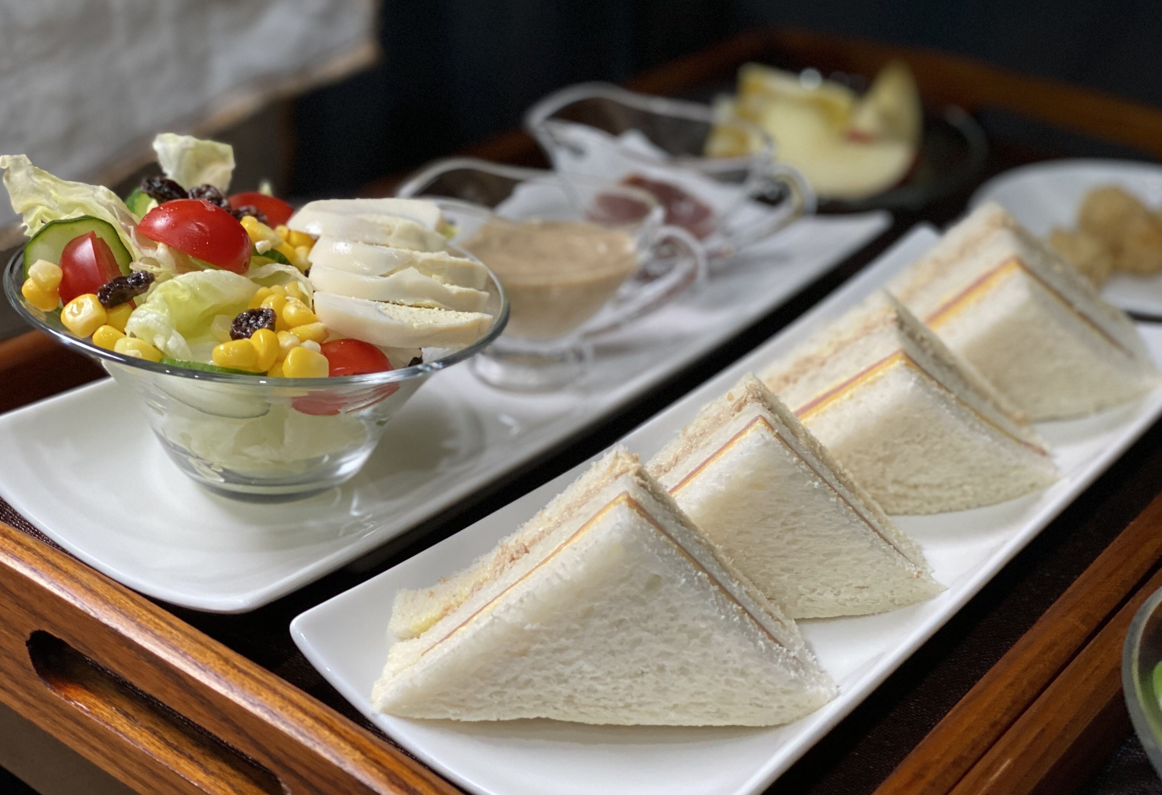 A tray with sandwiches and a salad.