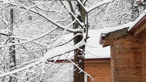 A wooden cabin with a snow-covered roof and a wooden door. - Yesil Dus Vadisi Bungalow Restoran (Kartepe)