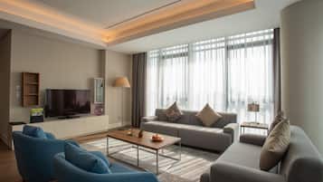 Deluxe Suite, 4 Bedrooms | Living room | LCD TV