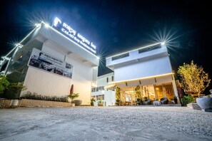 A hotel entrance with a modern design, featuring a prominent sign and a well-lit facade. - Calao Kep Residence Hotel (Kep)