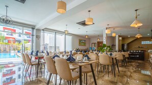 A restaurant with a pool view, modern furnishings, and a clean, spacious layout. - Calao Kep Residence Hotel (Kep)