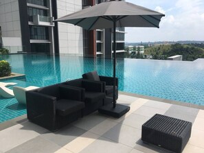 Relax by the pool surrounded by a city view.