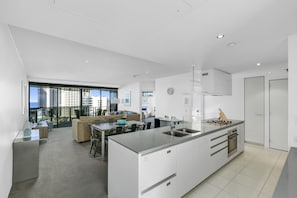 Enjoy a comfortable stay in this stylish apartment with a spacious kitchen, central island, and large window offering a view of the city.