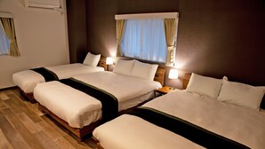 A hotel room with three beds, wooden headboards, and bedside lamps. - American Vintage Suite (Tokyo)