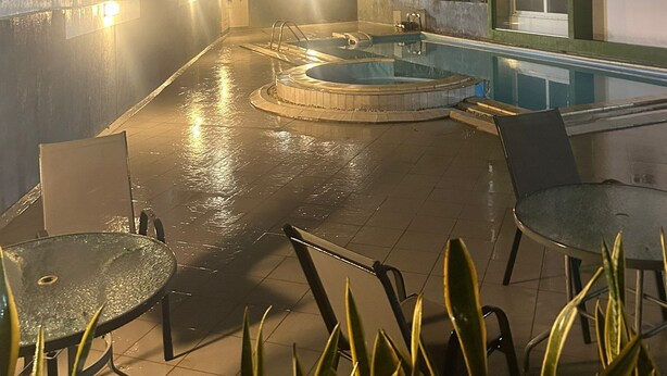 A rooftop pool area with a circular hot tub, lounge chairs, and a rectangular pool. - Premier Executive Apartment - The Ivy, East Legon (East Legon)