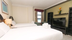 A hotel room with two beds, a TV, a desk, and a window with curtains. - 512 Parcial Ocean View Hollywood Beach Resort (Hollywood)