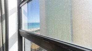 A window with a view of a beach and a building. - 716 Partial Ocean View (Hollywood)