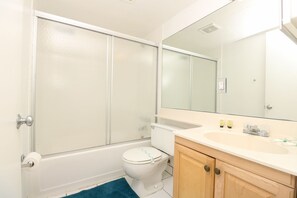 A bathroom with a bathtub, toilet, sink, and mirror. - 786 Partial Ocean Hollywood Beach (Hollywood)