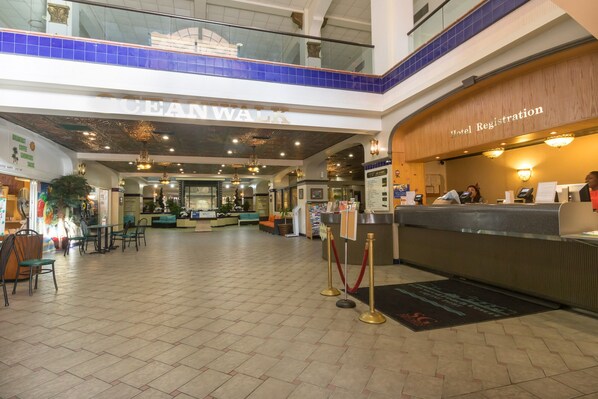 A hotel lobby with a reception desk, seating area, and a coffee shop. - 705 Partial Ocean View Hollywood Beach Resort (Hollywood)