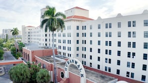 A multi-story building with a prominent "Oceanwalk" sign, featuring a red and white facade, numerous windows, and a flat roof. - 588 Partial Ocean View (Hollywood)