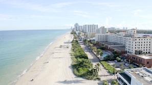 A beachfront hotel with a sandy beach, palm trees, and a view of the ocean. - 588 Partial Ocean View (Hollywood)