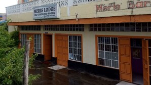 A building with a sign for 'Meri's Bar' and 'Meri's Lodge' indicating self-contained rooms. - Meris Lodge (Naivasha)
