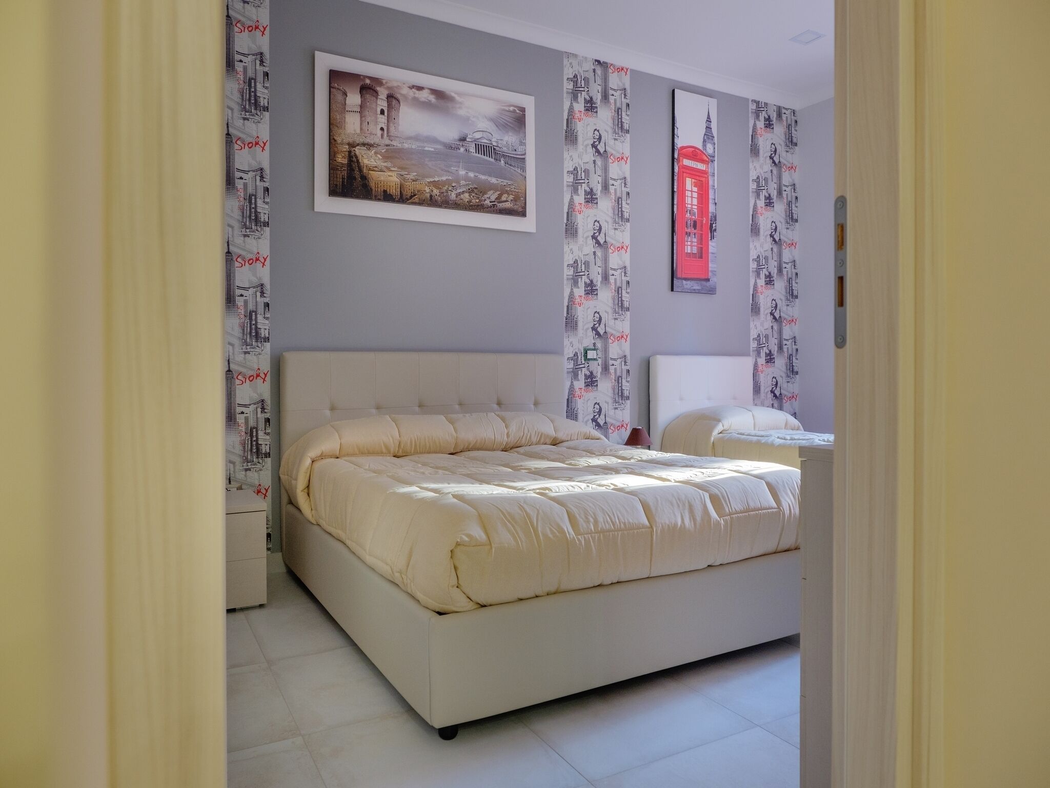 A bedroom with a large bed, a bedside table, and a nightstand.