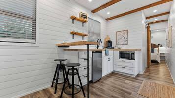 Fridge, microwave, coffee/tea maker, cookware/dishes/utensils