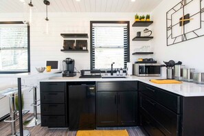 Fridge, microwave, coffee/tea maker, cookware/dishes/utensils