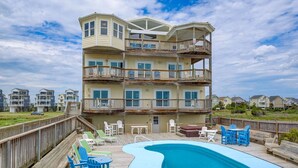 A multi-story building with a pool, outdoor seating, and a wooden deck. - 8 Bedroom Direct Oceanfront Home, Private Pool, Media Room, Private Beach Access, 2025 Updates (North Topsail Beach)