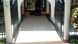 A gated entrance with a staircase leading to a building. - Pyramid Restaurant (Naivasha)