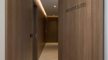 A hallway with wooden walls and a sign reading "EXECUTIVE SUITES".