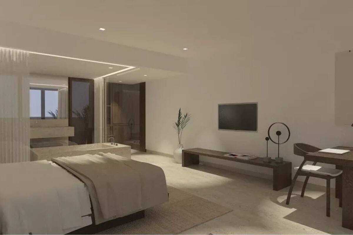 Ein modernes Schlafzimmer mit Bett, Nachttisch, Schreibtisch, Stuhl und Fernseher.