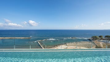 Seasonal outdoor pool, open 9:30 AM to 6:30 PM, pool umbrellas