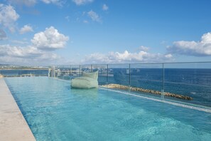 Seasonal outdoor pool, open 9:30 AM to 6:30 PM, pool umbrellas