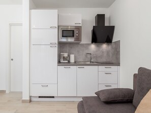 Enjoy cooking in this well-equipped kitchen with a range, sink, and microwave.