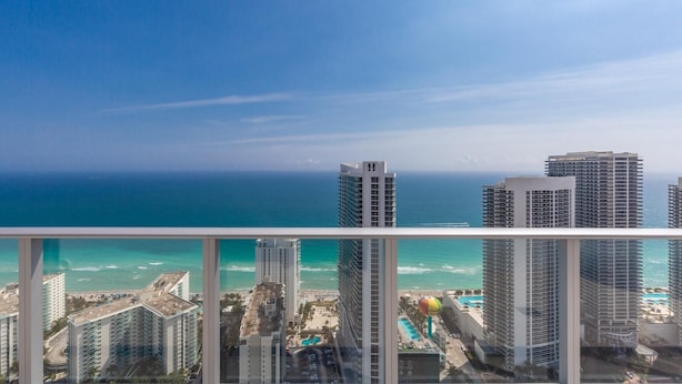 A high-rise hotel with multiple floors, a pool area, and a view of the ocean. - 43rd Floor Penthouse Ocean Views Private Terraces (Hollywood)