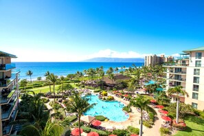 Resort paradise with ocean views, pools, palm trees, tropical bliss.