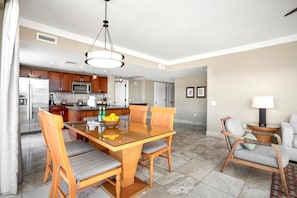 Open-concept luxury suite with gourmet kitchen, elegant dining, island living.