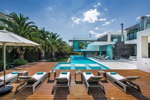 A modern pool area with lounge chairs and a clear view of the pool.