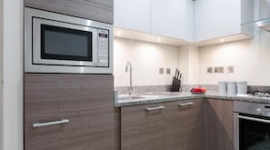 Appartement Design | Cuisine privée | Grand réfrigérateur, micro-ondes, four, plaque de cuisson